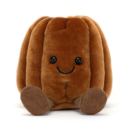 Peluche en forme de canelé bordelais marron avec petit sourire et jambes en velours, collection Jellycat Amuseables.