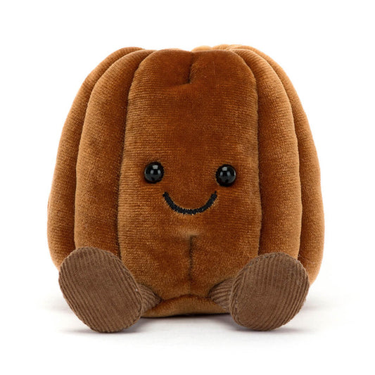Peluche en forme de canelé bordelais marron avec petit sourire et jambes en velours, collection Jellycat Amuseables.