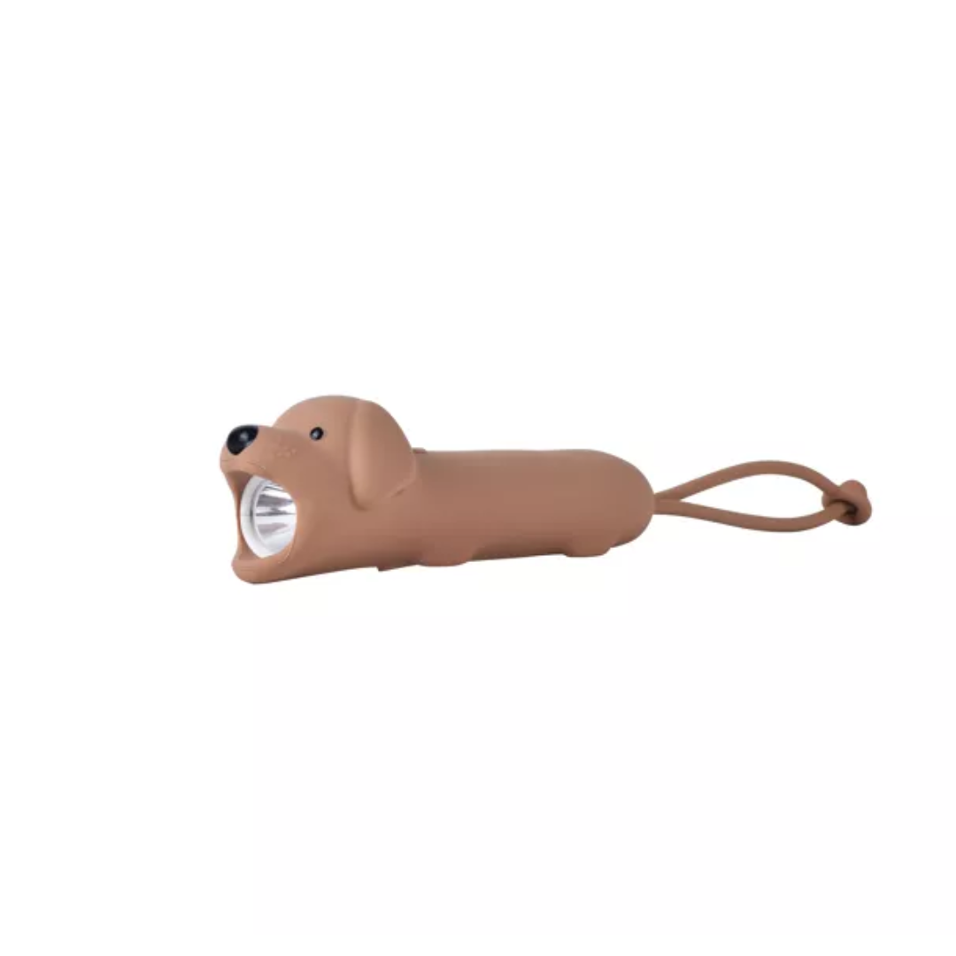 Lampe de poche LED marron en forme de chien assis en silicone souple avec sangle de transport.