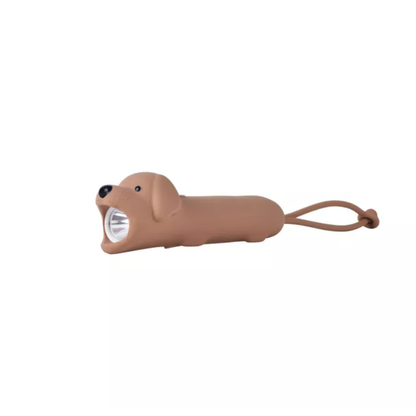 Lampe de poche LED marron en forme de chien assis en silicone souple avec sangle de transport.