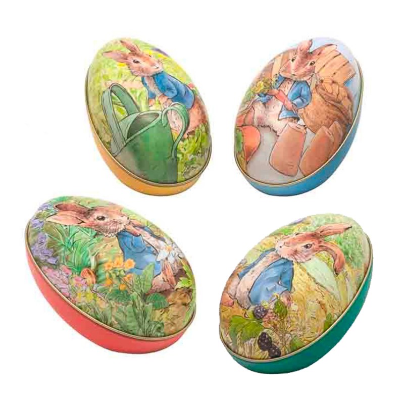 Œufs en métal à garnir illustrés avec le personnage de Peter Rabbit, différents coloris et décors de jardin.