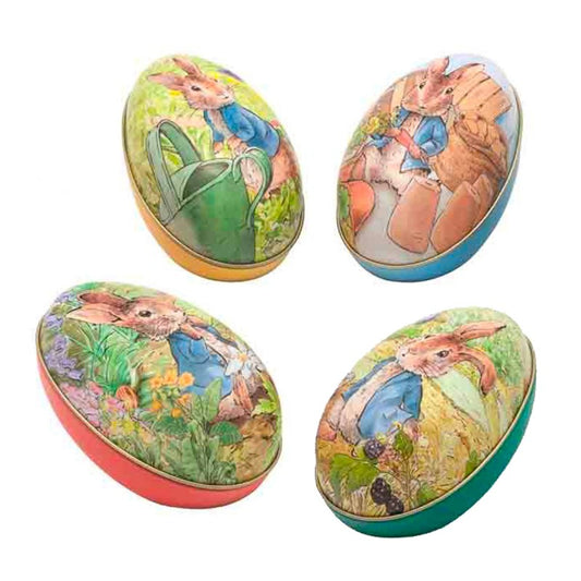 Œufs en métal à garnir illustrés avec le personnage de Peter Rabbit, différents coloris et décors de jardin.